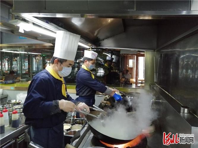 在河北渝乡辣婆婆餐饮管理和平店后厨,厨师正在炒菜.